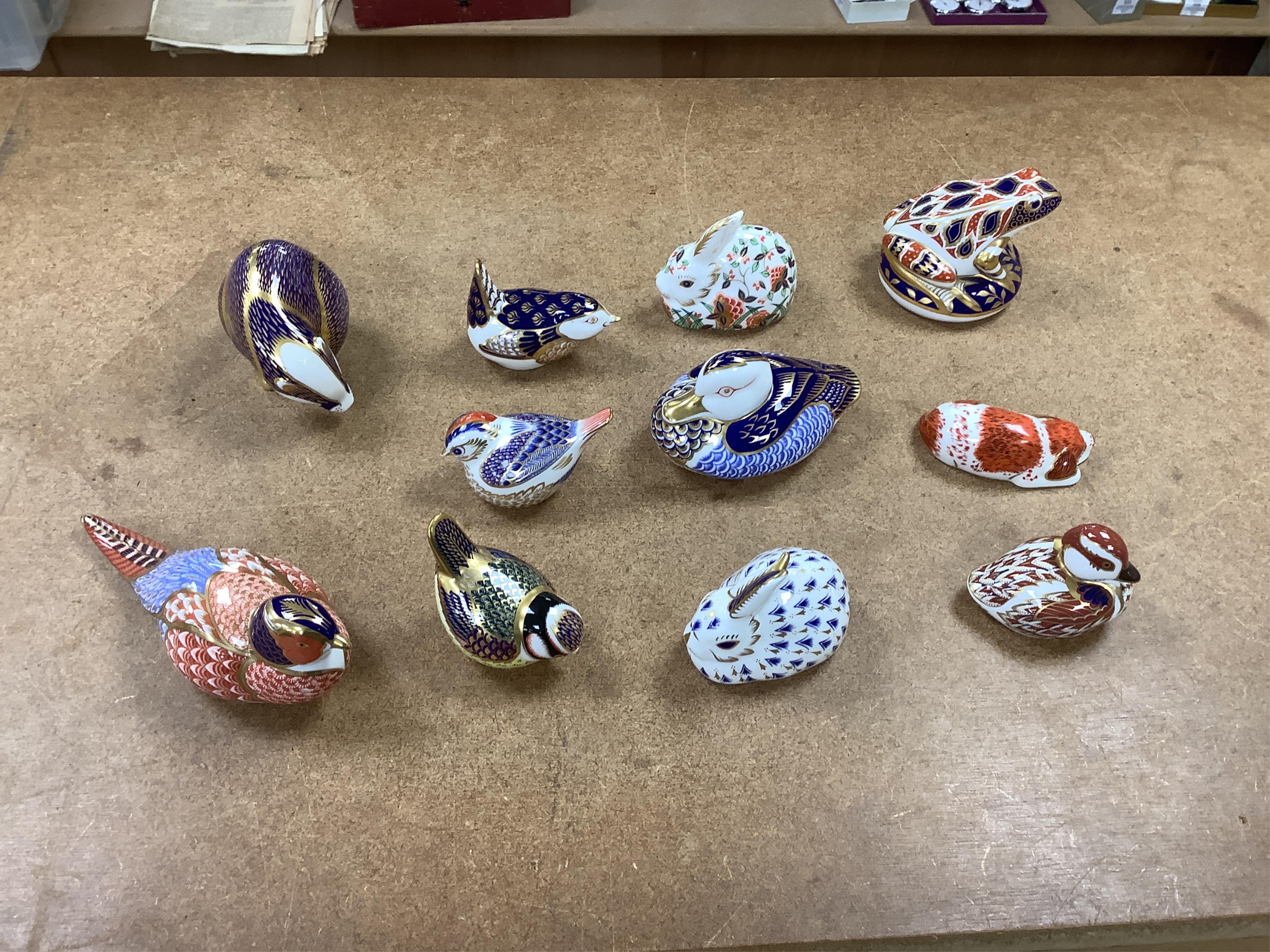 A collection of Royal Crown Derby Imari pattern paperweights, to include penguin and badger, together with three Doulton flambé animals, largest 19cm wide